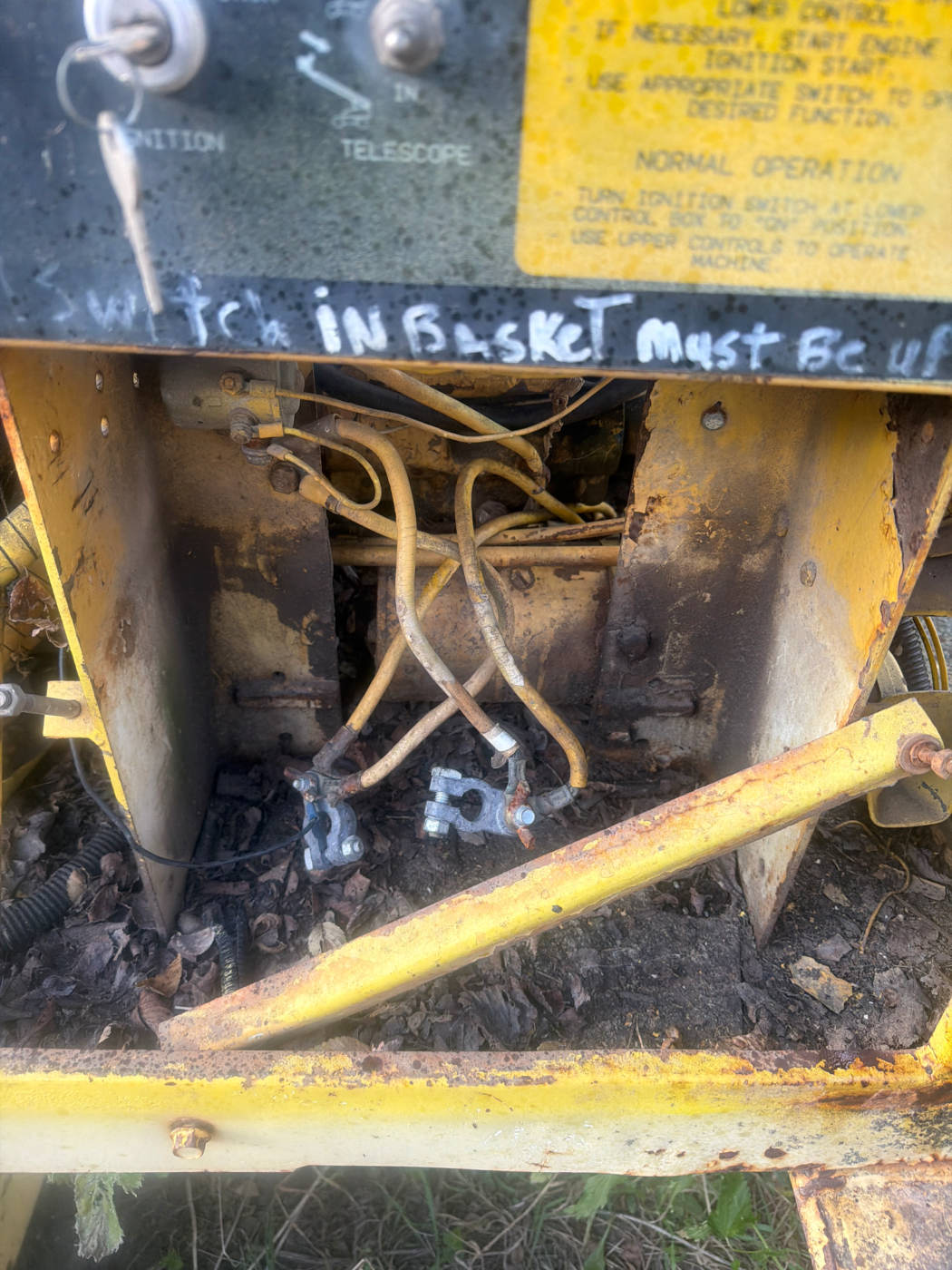 Empty battery tray with cables hanging, under the ground control panel
