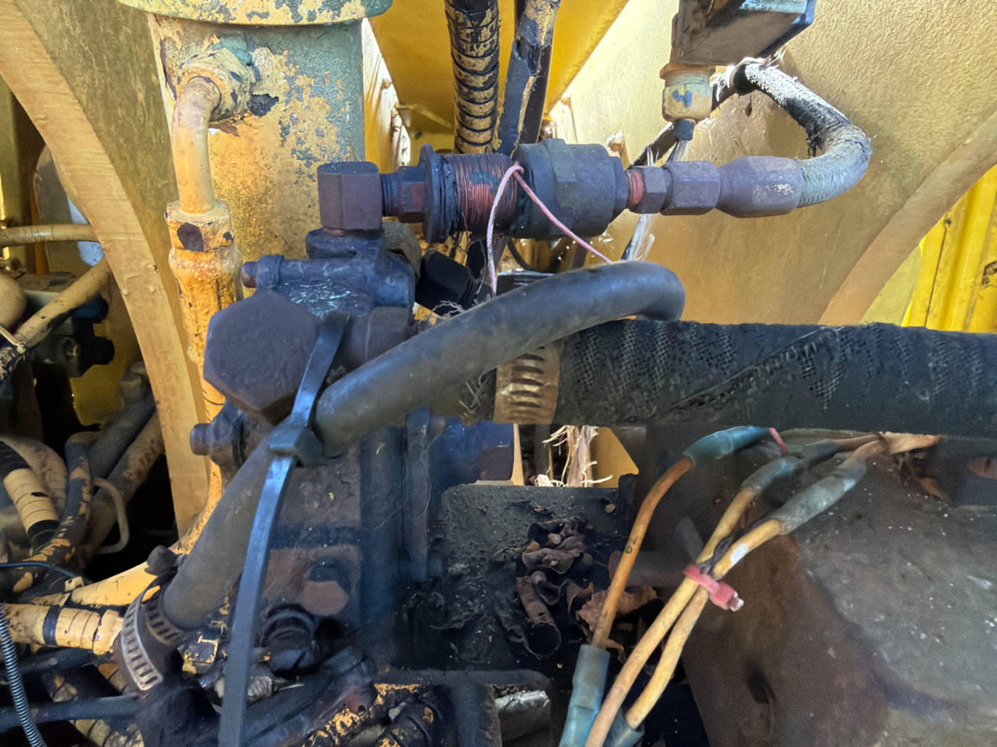 The coil in question: wound copper on a fitting in the LP line, not on the hydraulic manifold