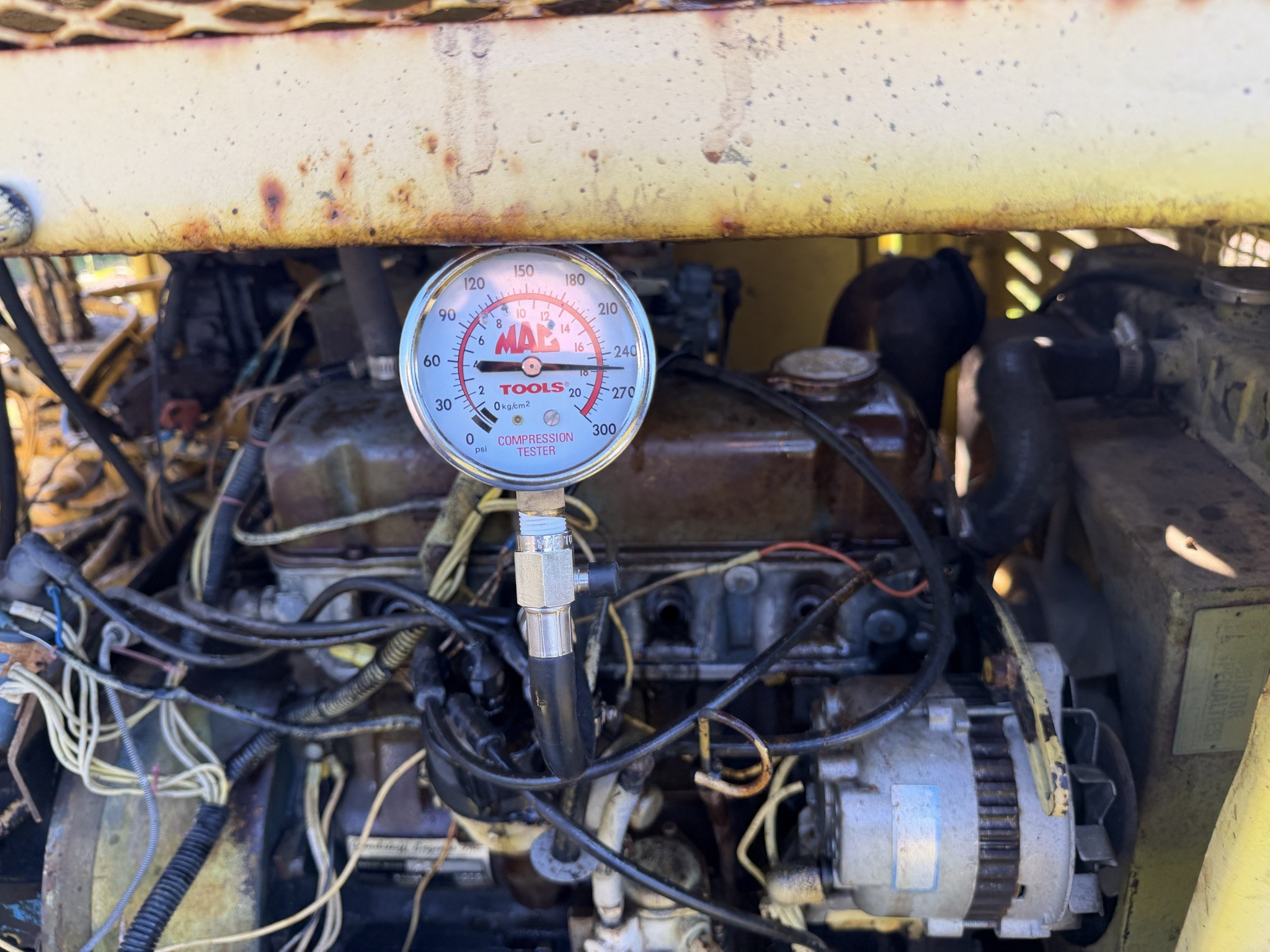Compression gauge, pointer again out between 240 and 270 psi