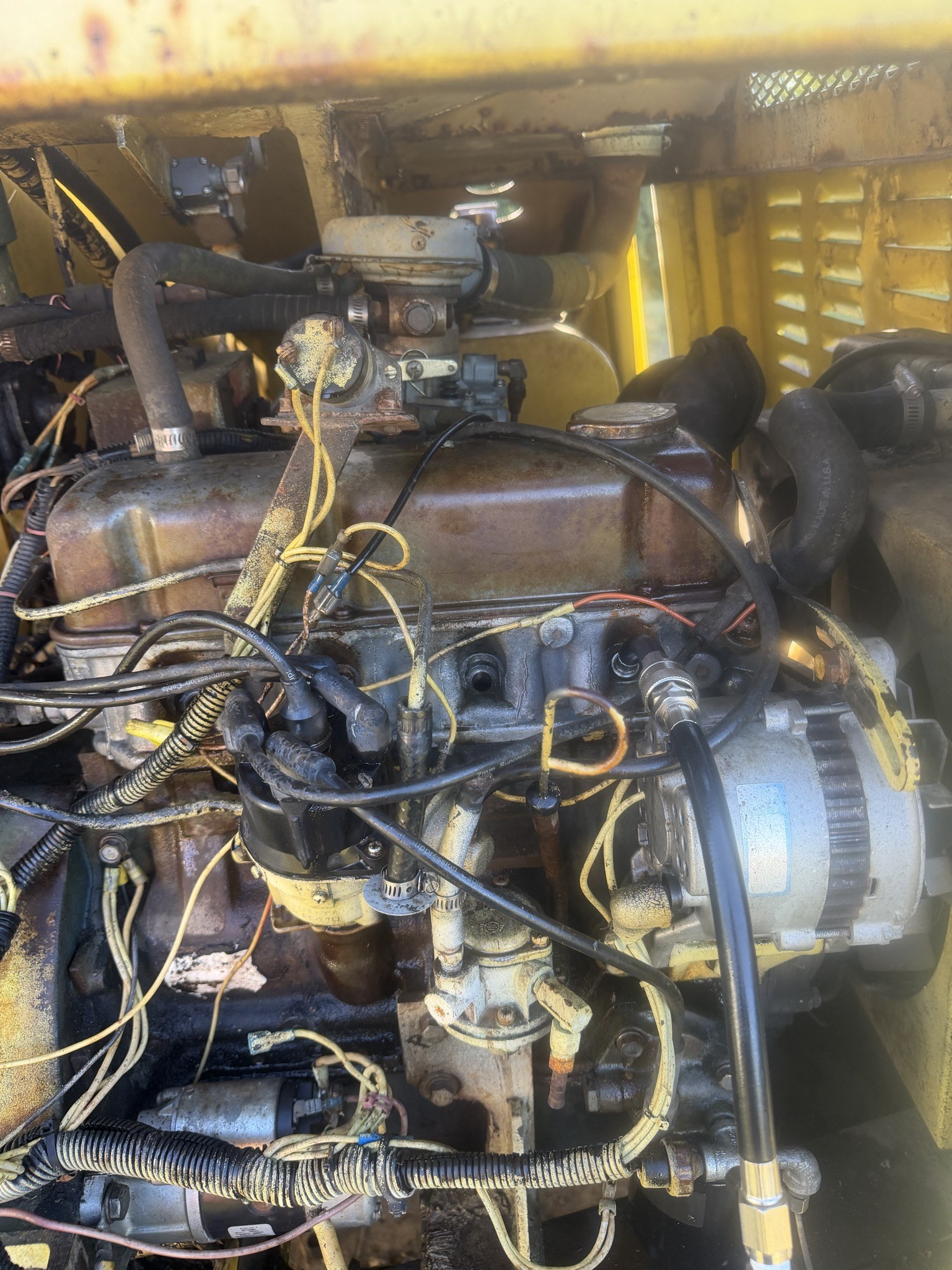 Engine bay from above, distributor and plug leads in place